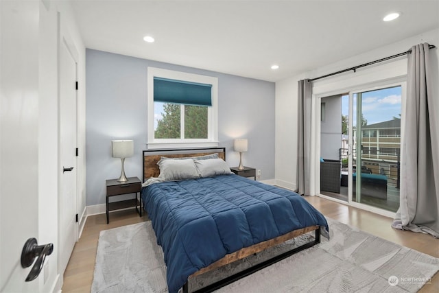 bedroom featuring recessed lighting, multiple windows, and access to exterior