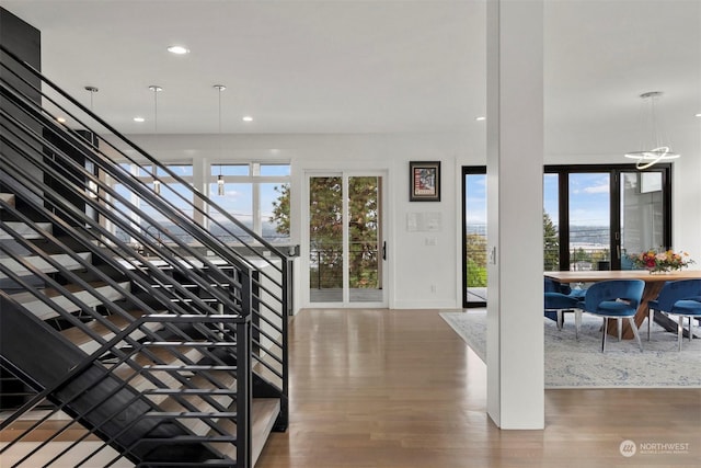 interior space with recessed lighting, stairway, wood finished floors, and a healthy amount of sunlight