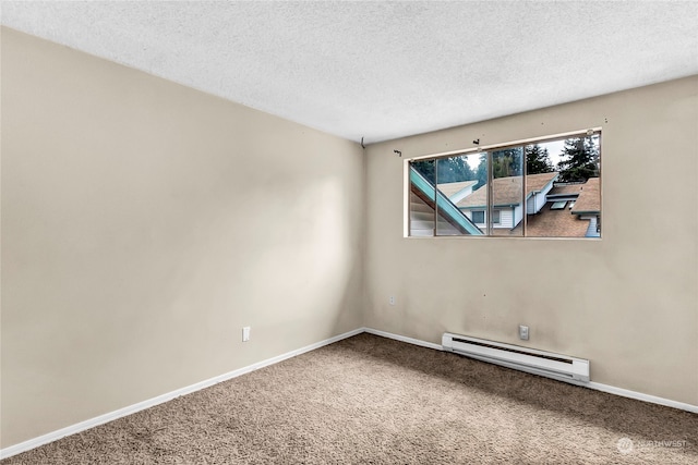 carpeted spare room featuring a textured ceiling and baseboard heating