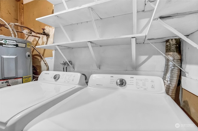 laundry area with washer and clothes dryer and water heater