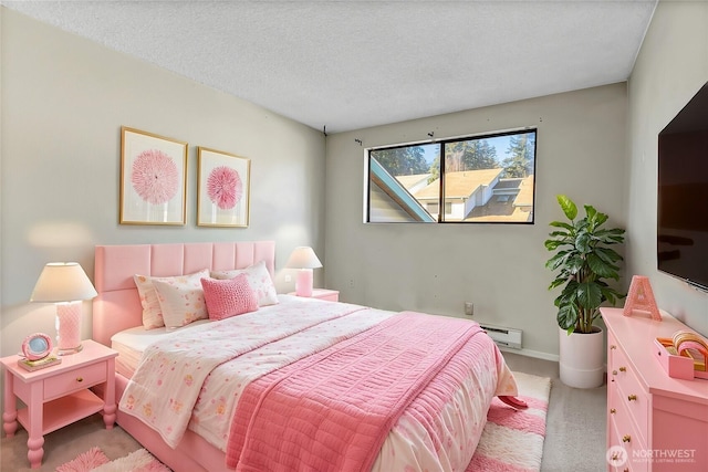 carpeted bedroom featuring a textured ceiling and a baseboard heating unit