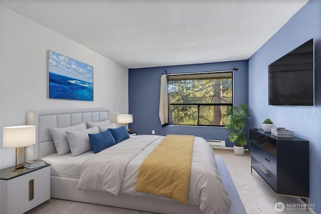 bedroom featuring a baseboard radiator, light colored carpet, and a textured ceiling