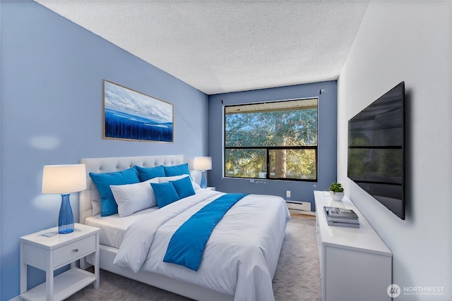 carpeted bedroom with a baseboard heating unit and a textured ceiling