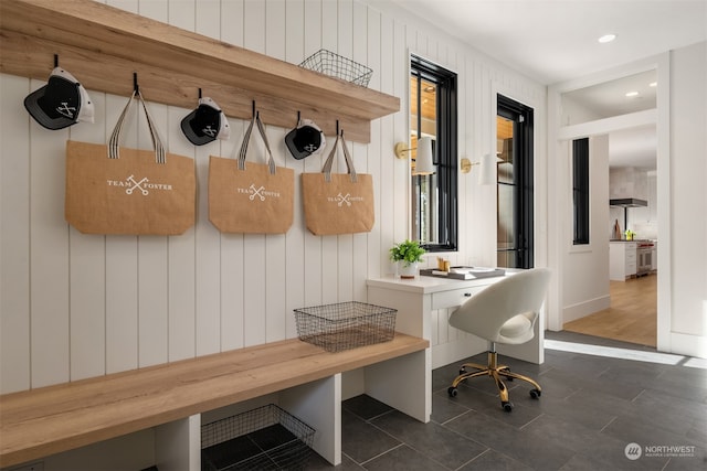 mudroom with dark tile patterned flooring