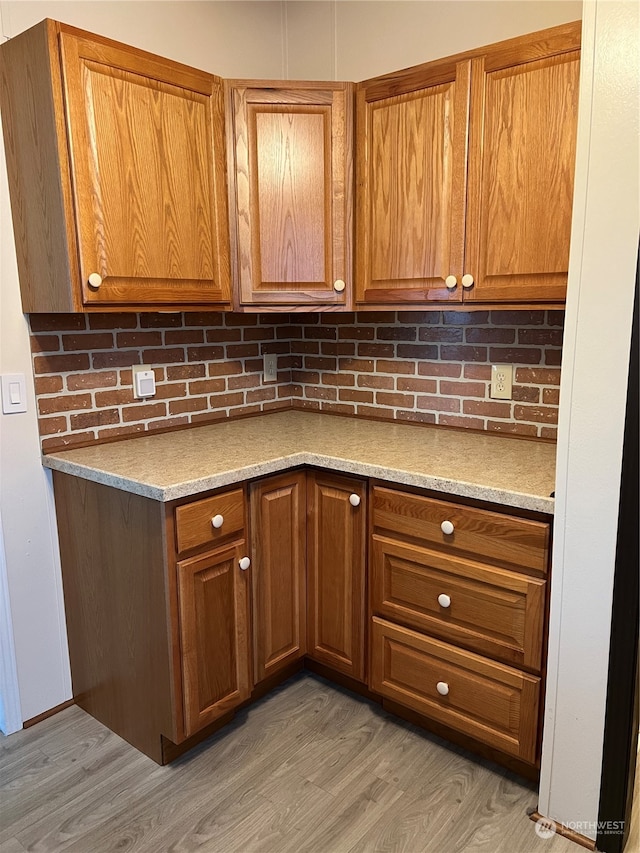 kitchen with hardwood / wood-style flooring and decorative backsplash