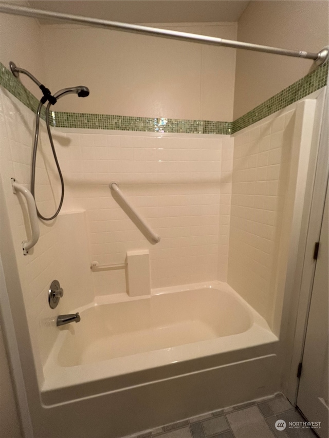 bathroom with tiled shower / bath combo and tile patterned flooring