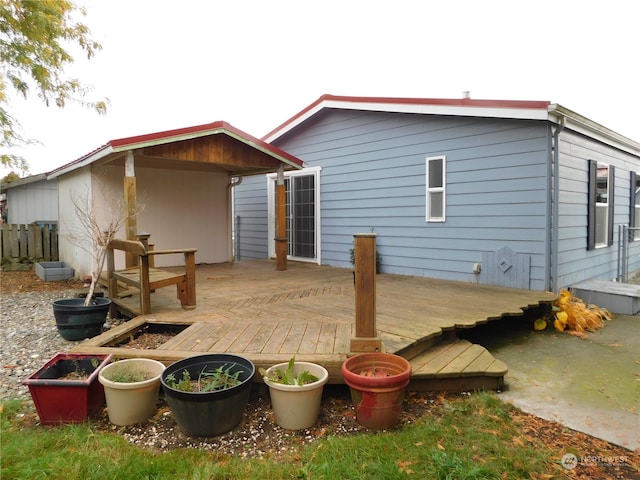 back of house featuring a wooden deck