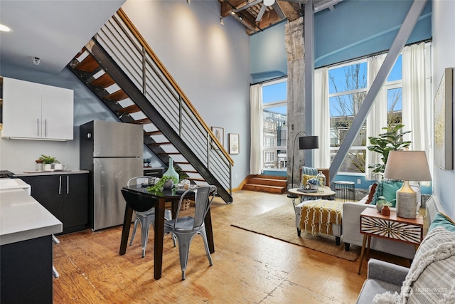 interior space featuring a towering ceiling and light hardwood / wood-style floors