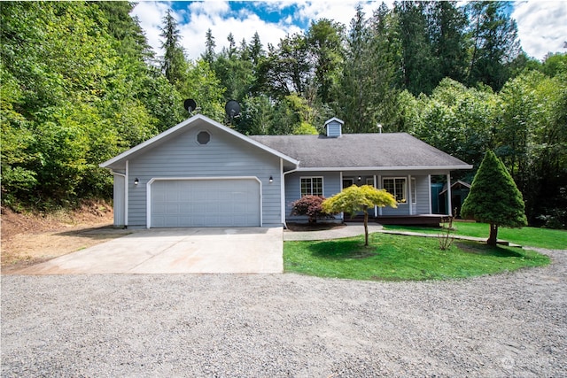 ranch-style house featuring a front yard and a garage