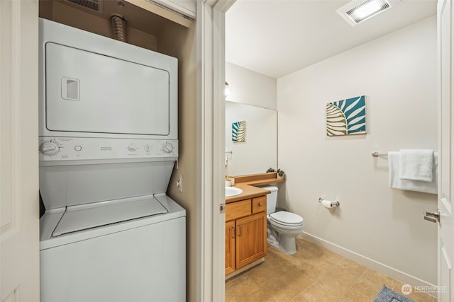 laundry area with stacked washer and dryer