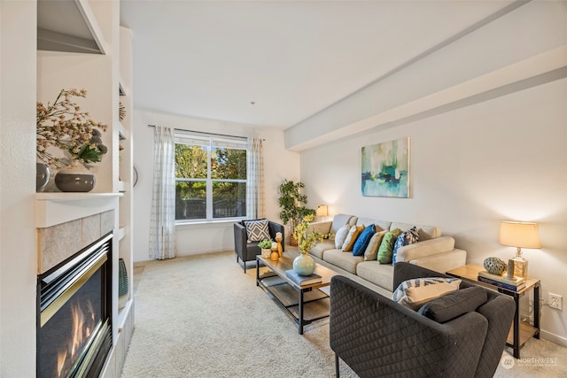 carpeted living room featuring a tiled fireplace