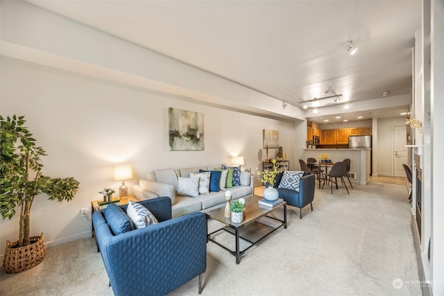 carpeted living room with rail lighting