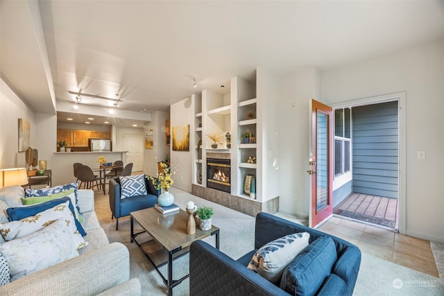 living room with light tile patterned floors and rail lighting