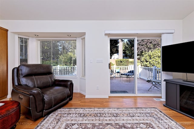 living area with hardwood / wood-style flooring and a wealth of natural light