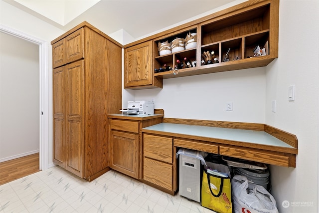 kitchen featuring built in desk and light hardwood / wood-style flooring