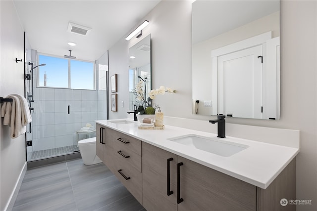 bathroom with walk in shower, vanity, and toilet