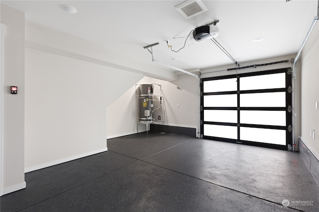 garage with a garage door opener and secured water heater