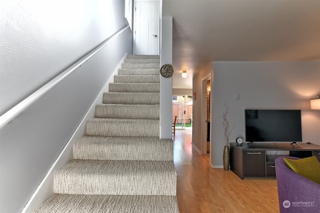 stairs with hardwood / wood-style floors