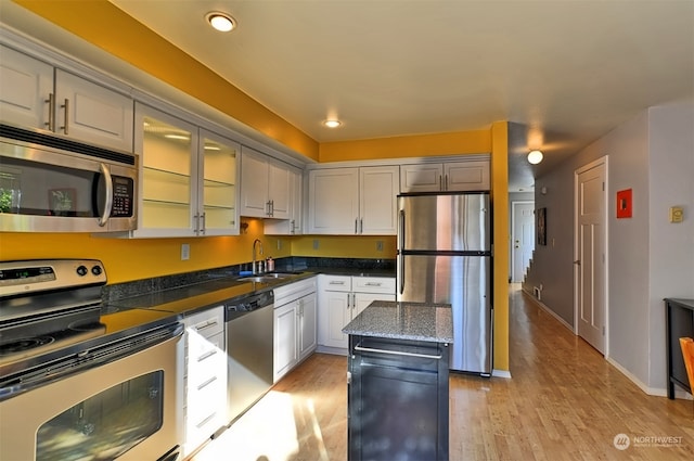 kitchen featuring a center island, sink, stainless steel appliances, and light hardwood / wood-style flooring