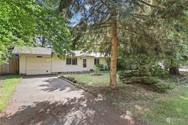 view of front of house featuring a front yard and a garage