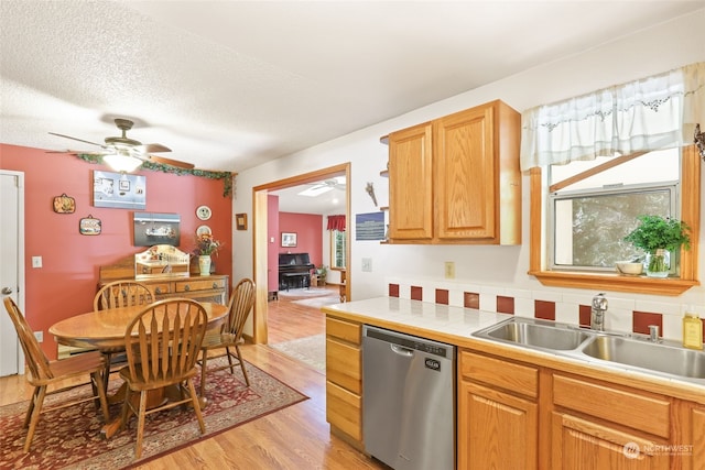 kitchen featuring ceiling fan, light hardwood / wood-style flooring, sink, dishwasher, and a textured ceiling