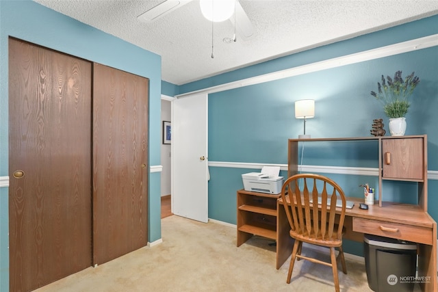 office area with ceiling fan, light colored carpet, and a textured ceiling