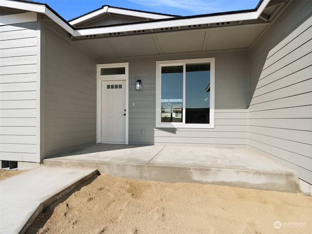 entrance to property featuring a patio area