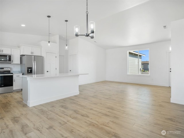334 Spring Cir SW Unit 69, Mattawa, WA 99349 - kitchen with light wood finished floors, stainless steel appliances, white cabinets, light countertops, and lofted ceiling