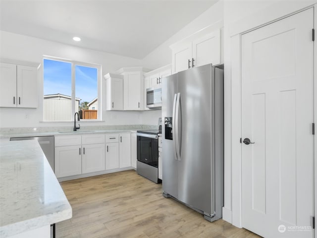 334 Spring Cir SW Unit 69, Mattawa, WA 99349 - kitchen with a sink, light stone counters, light wood finished floors, white cabinetry, and appliances with stainless steel finishes