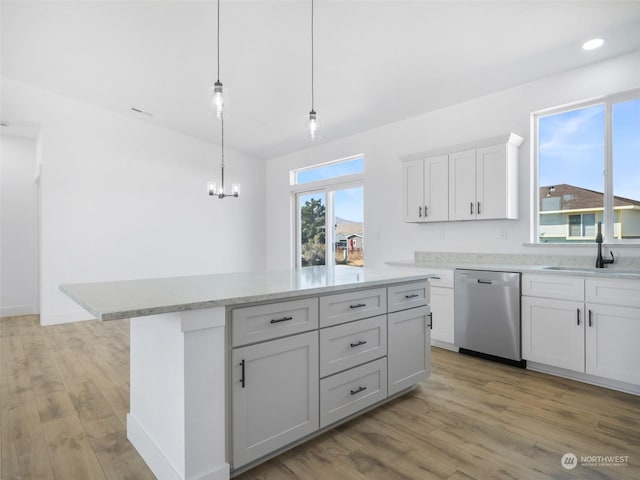 334 Spring Cir SW Unit 69, Mattawa, WA 99349 - kitchen with a sink, light wood finished floors, a chandelier, stainless steel dishwasher, and light stone countertops