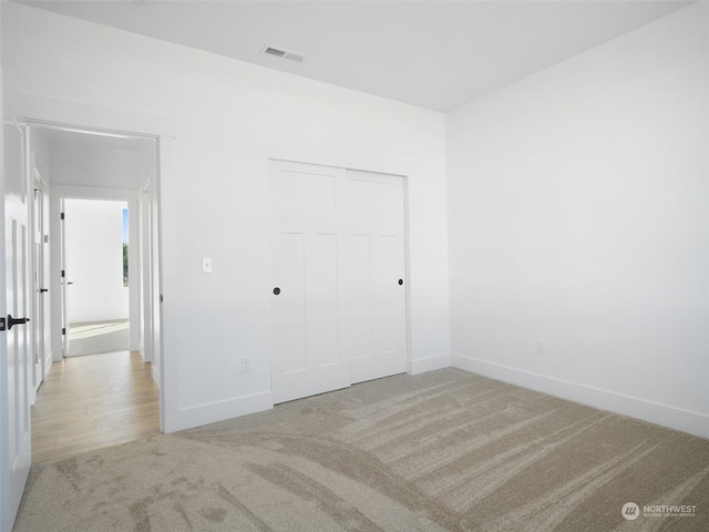 334 Spring Cir SW Unit 69, Mattawa, WA 99349 - unfurnished bedroom with light colored carpet, baseboards, a closet, and visible vents