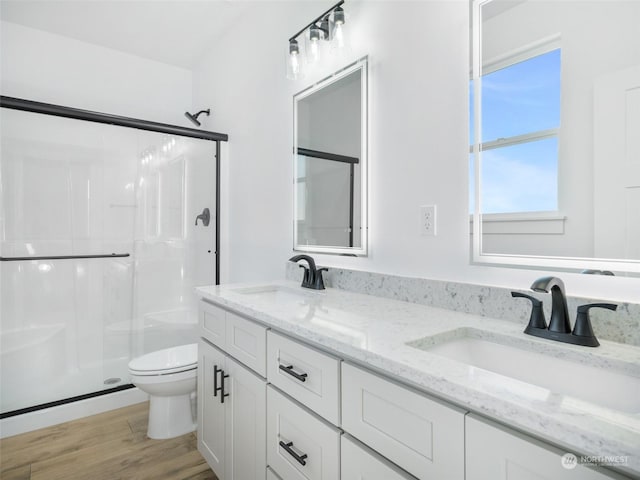 334 Spring Cir SW Unit 69, Mattawa, WA 99349 - full bathroom with a sink, toilet, a shower stall, and wood finished floors