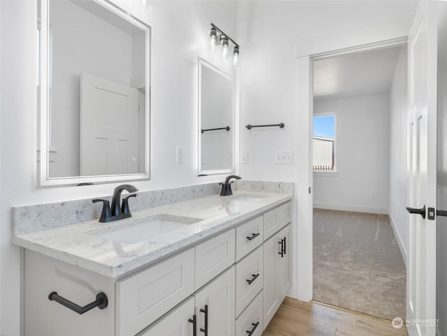 334 Spring Cir SW Unit 69, Mattawa, WA 99349 - full bathroom with double vanity, wood finished floors, baseboards, and a sink