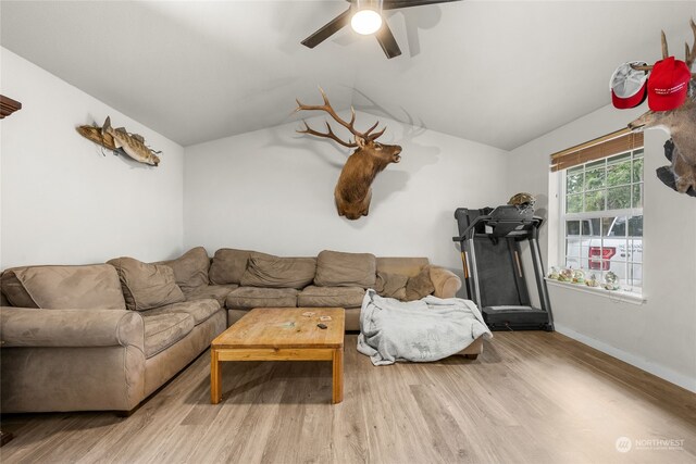 living room with ceiling fan, vaulted ceiling, and light hardwood / wood-style floors