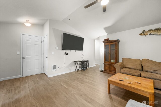 living room with lofted ceiling, ceiling fan, and light hardwood / wood-style floors