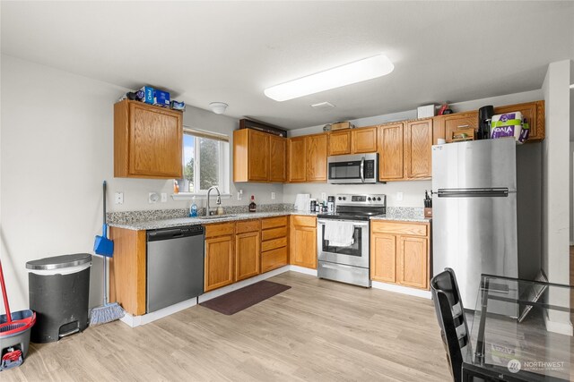 kitchen featuring light hardwood / wood-style floors, appliances with stainless steel finishes, and sink