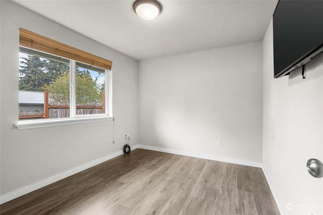 empty room with wood-type flooring