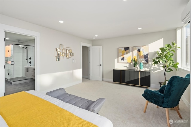 carpeted bedroom with a wall mounted air conditioner and ensuite bath