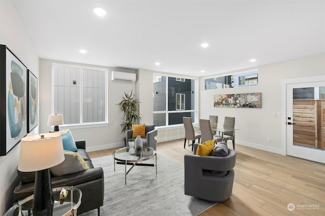 living room featuring a wall unit AC and light wood-type flooring