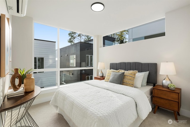 carpeted bedroom with a wall mounted AC