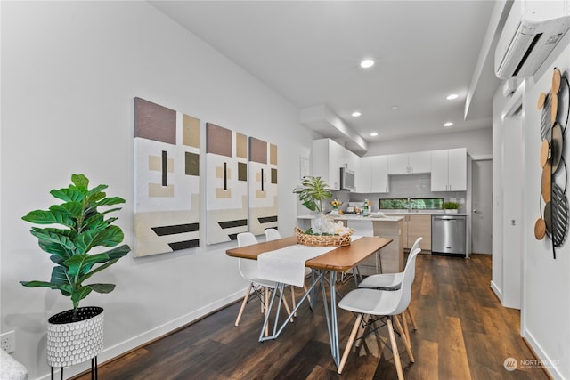 dining area featuring a wall mounted air conditioner, sink, and dark wood-type flooring