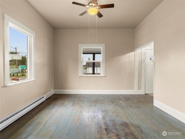 spare room with ceiling fan, a baseboard heating unit, and wood-type flooring