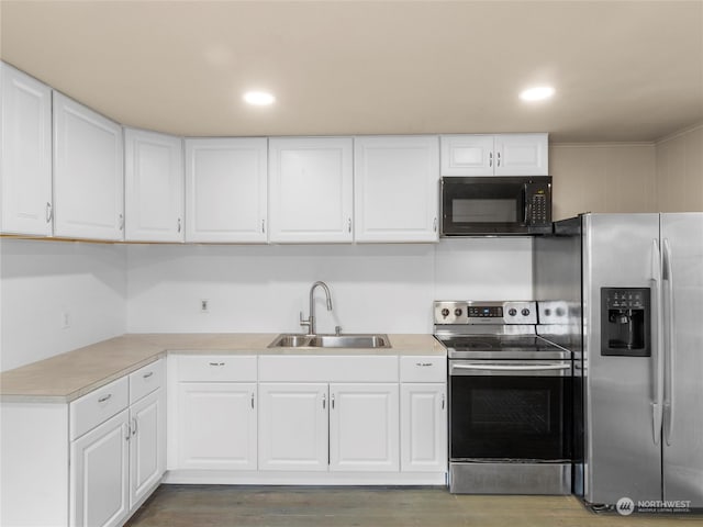 kitchen with white cabinetry, sink, stainless steel appliances, and dark hardwood / wood-style flooring