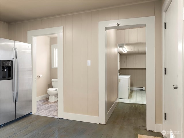 corridor with washer and dryer, crown molding, hardwood / wood-style flooring, and a baseboard radiator