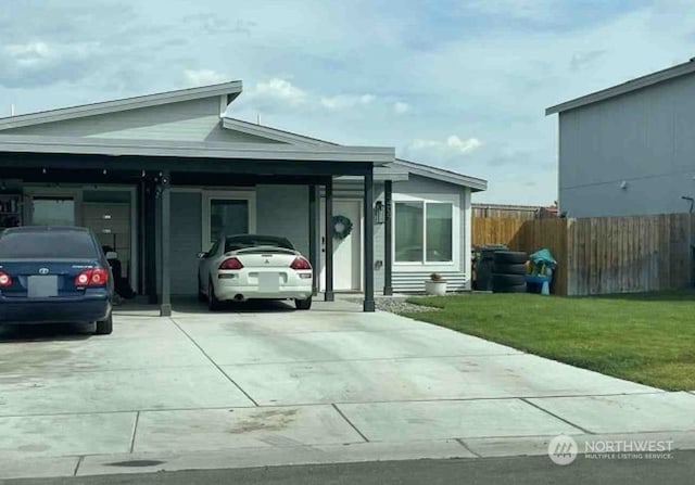 view of front of home with a front lawn and a carport