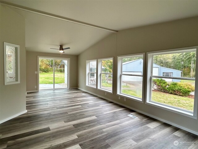 unfurnished sunroom featuring ceiling fan and vaulted ceiling