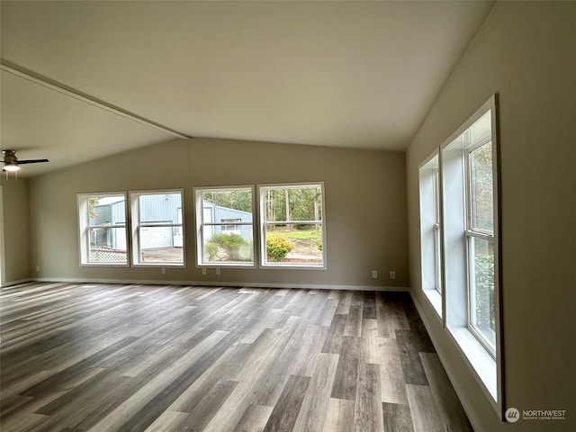 unfurnished room with ceiling fan, hardwood / wood-style flooring, and lofted ceiling