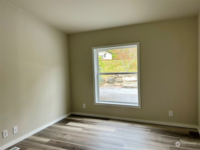 spare room with light hardwood / wood-style floors