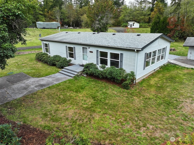 ranch-style home with a front lawn