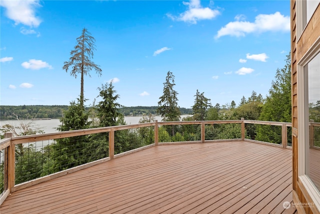 wooden terrace featuring a water view